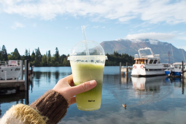 plastic cup with green liquid